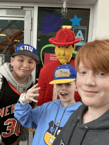 a boy wearing a hat that says vegas is standing next to two other boys