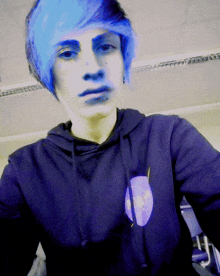 a boy with blue hair is wearing a hoodie