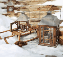 a wooden sled sits in the snow next to a lantern that says ' winter ' on it