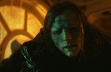a close up of a person with long hair and a scary face