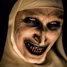 a close up of a nun 's face with a big smile on it