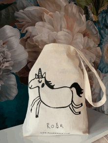 a tote bag with a picture of a unicorn and the word roar on the bottom