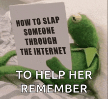 a kermit the frog is holding a card that says how to slap someone through the internet to help her remember