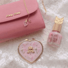 a bottle of maison de reefur nail polish is next to a pink purse