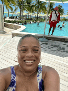 a woman taking a selfie with a lifeguard behind her