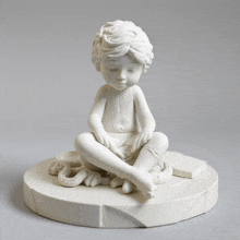 a white statue of a child sitting on a circle with his eyes closed