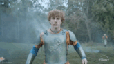 a young man with curly hair is wearing a knight 's outfit from disney +
