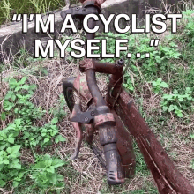 an old rusty bicycle is sitting in the grass with the words " i 'm a cyclist myself " above it