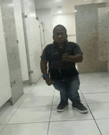 a small man taking a selfie in a bathroom