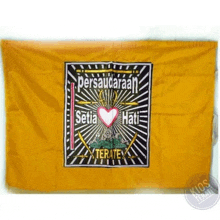 a yellow flag with a heart and swords on it is sitting on a table .