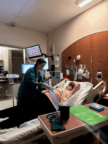 a woman in a hospital bed is being examined by a doctor