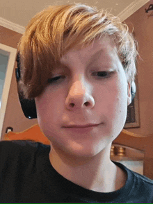 a young boy wearing headphones and a black shirt