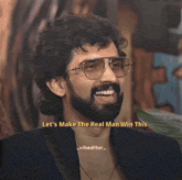 a man with a beard is smiling and says let 's make the real man win this vibeeditor