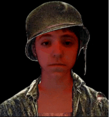 a young boy wearing a military helmet looks at the camera with a serious look on his face