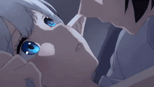a boy and a girl are kissing in a dark room