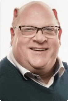 a bald man wearing glasses and a blue shirt is smiling .