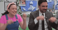 a man and a woman are dancing together in a room .