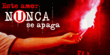 a person holding a red torch with the words " este amor nunca se apaga " written on it