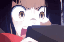 a girl with a surprised look on her face is playing a video game on a tablet .