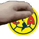 a hand is holding a yellow circle with a red letter a on it .