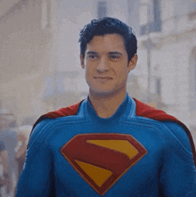a man in a superman costume with the letter s on the chest