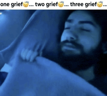 a man laying in bed with the words one grief two grief three grief