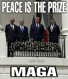 a group of men standing on a balcony with the words peace is the prize maga