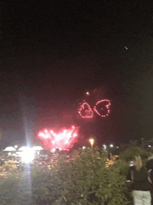 a fireworks display at night with the letters a and g in the sky