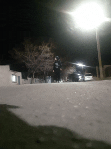 a person wearing a hoodie that says ' i love you ' on it walks down a street at night