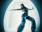 a woman in a futuristic outfit is standing in a hallway