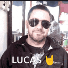 a man wearing sunglasses has the name lucas on his shirt