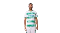 a man wearing a green and white hofmann soccer jersey