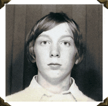 a black and white photo of a young man with red hair