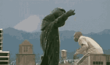 a man in a white jacket is fighting a giant monster .