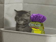 a frog wearing a purple shower cap sits in a bathtub