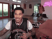 a man wearing a basketball jersey that says ' nverson ' on it