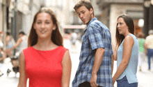 a man in a plaid shirt is looking at a woman in a red top