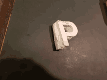 a white letter p is sitting on a table