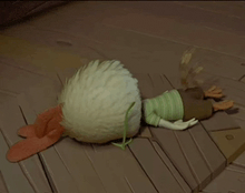a cartoon character is laying on the floor with a chicken laying on its back
