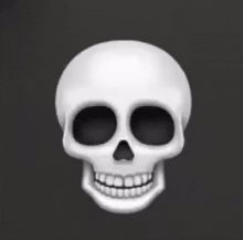 a white skull with black eyes and teeth is smiling .