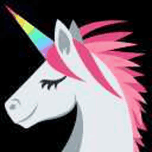 a unicorn with a rainbow horn and pink mane is smiling .