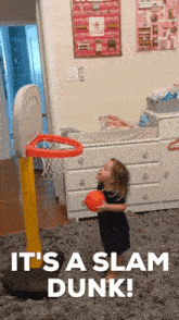 a little girl holding a basketball in front of a basketball hoop with the words it 's a slam dunk