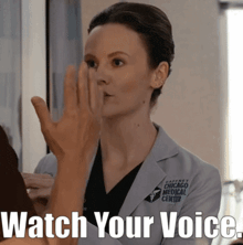 a woman in a chicago medical center uniform holds her hand to her mouth
