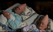 a man and a woman with cones on their heads are laying in a bed