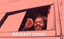 a man is waving from the window of a car and the words beeeast coast are visible .