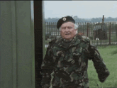 a man in a military uniform has a badge on his hat with the letter o on it