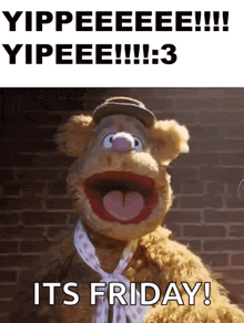muppet fozzie bear says it 's friday while wearing a hat and scarf