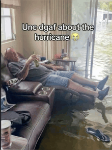 a man is laying on a couch in a flooded living room