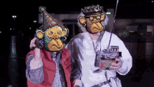 a pixel art of a man and a monkey wearing party hats and holding a radio .