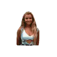 a woman in a white top and blue shorts smiles for the camera